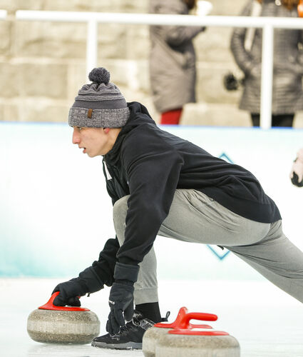 Boy Curling on Ice