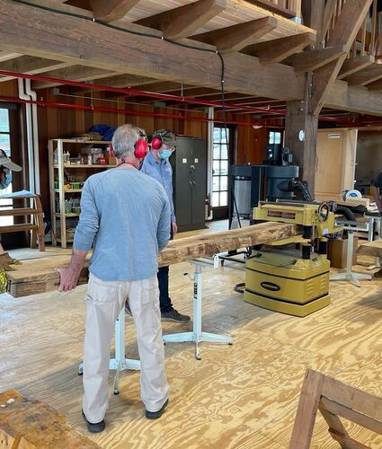 Volunteers Cutting Wood at the Longshed