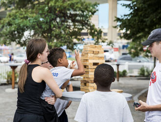 Enlarge image: Family Playing Giant Outdoor Jenga