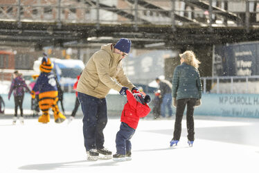 Enlarge image: Dad Skating With Boy on Ice Rink